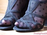 young girl tease with her feet in black pantyhose