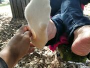 Maleka red toes and soles on a bench