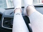 she shows off her cute white socks in the car