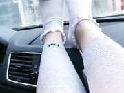 she shows off her cute white socks in the car