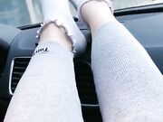 she shows off her cute white socks in the car