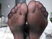 tease with feet in black stockings