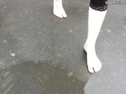Girn enjoying barefooting in the rain