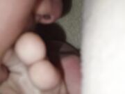 The teen boy lickling his foots