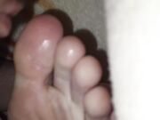 The teen boy lickling his foots